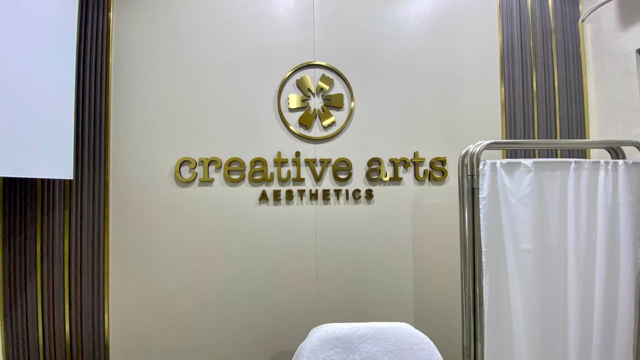 Creative Arts Aesthetics gold reception logo sign