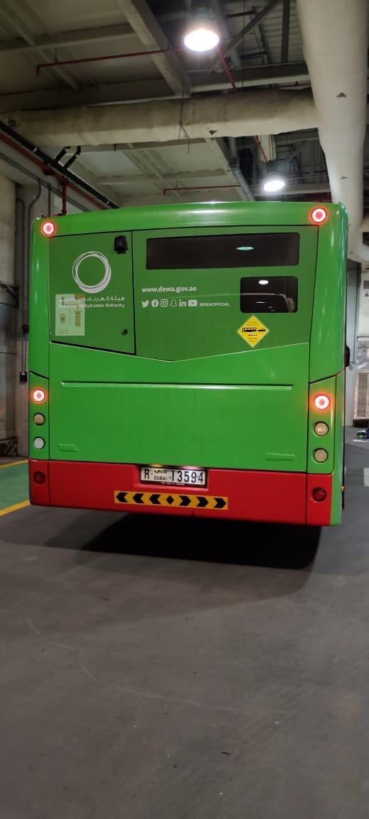Rear advertising graphics on a green public bus
